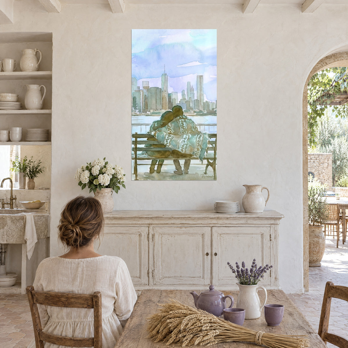 Wall art, watercolor of a kiss on the shoulder facing the river and towers, periwinkle blue and brown, young woman seen from behind seated at a table in a farmhouse kitchen