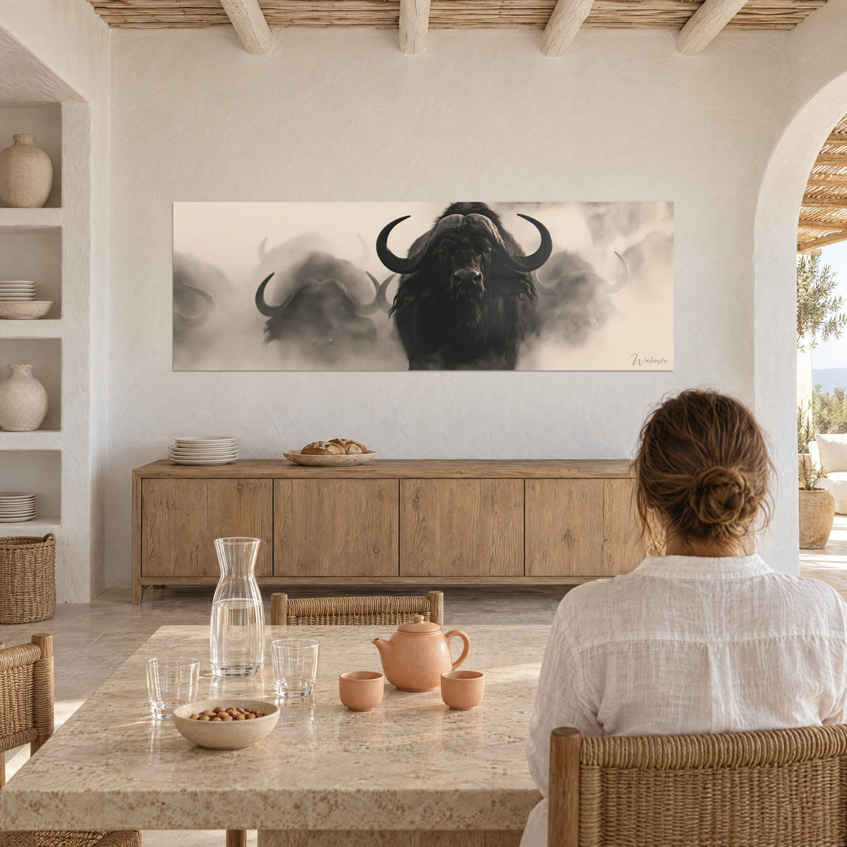 Wall art Frontal portrait of a Cape buffalo, dark gaze, ivory and warm brown haze, white wall, light wooden sideboard, set table