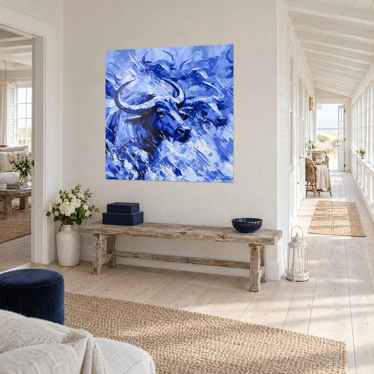 Wall art herd of bison charging through a storm, ultramarine blue and icy white, in perspective at the end of a seaside house hallway