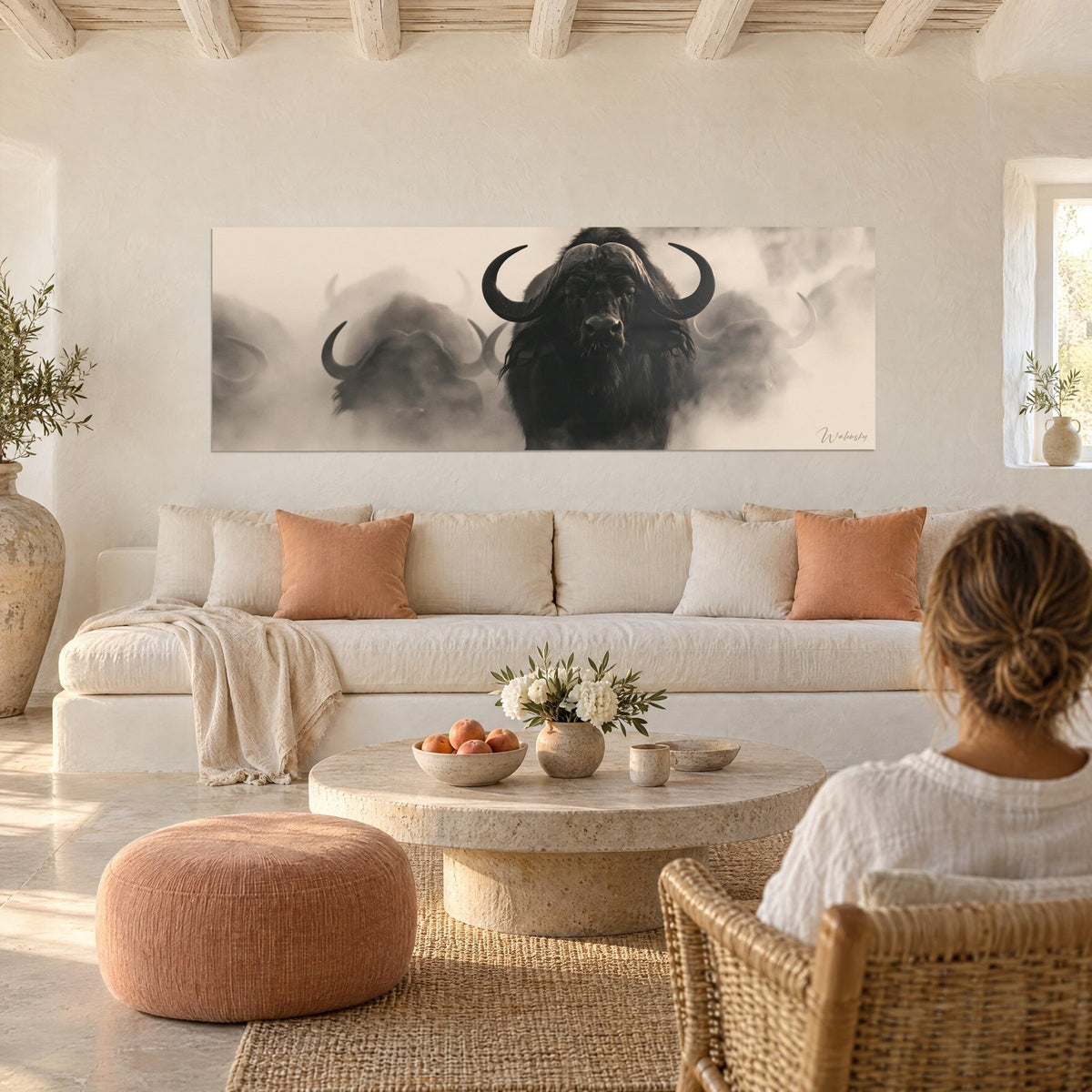 Wall art Black buffalo with curved horns emerging from a sepia mist, ivory and brown, above a sofa in a bright living room