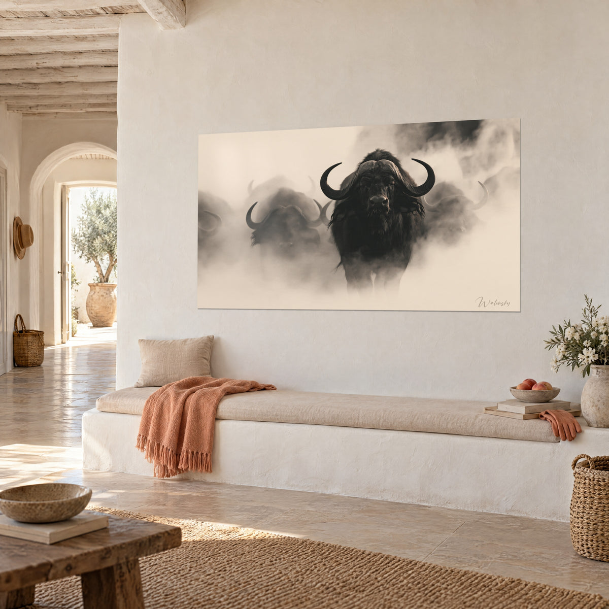 Tableau taureau sauvage face caméra, cornes massives, pelage noir et brume crème, sur un mur blanc d'une maison au soleil