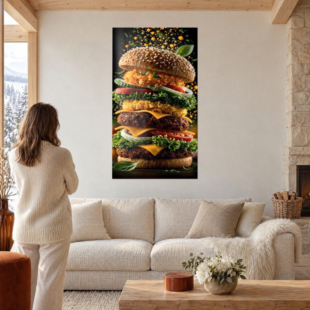 Wall art with a giant burger, two stacked patties, brown sesame bun, orange cheddar and green lettuce, woman seen from behind, above a sofa in a bright living room