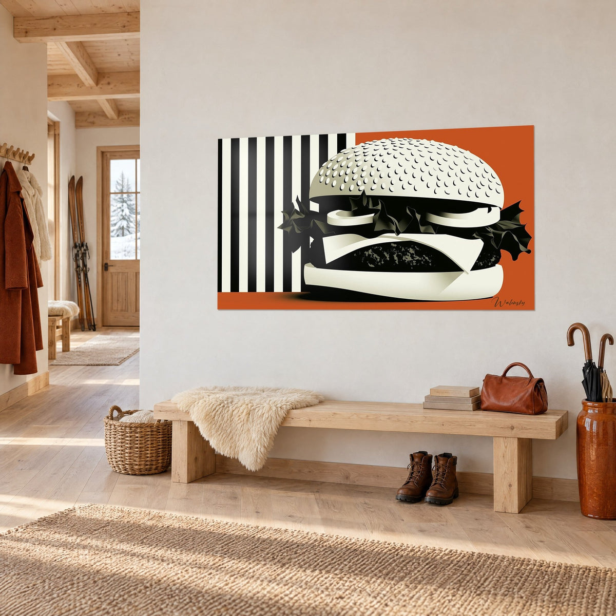 Tableau sandwich géant en aplats ivoire et noir, salade froissée sur fond orange brûlé, accroché dans une entrée en bois clair