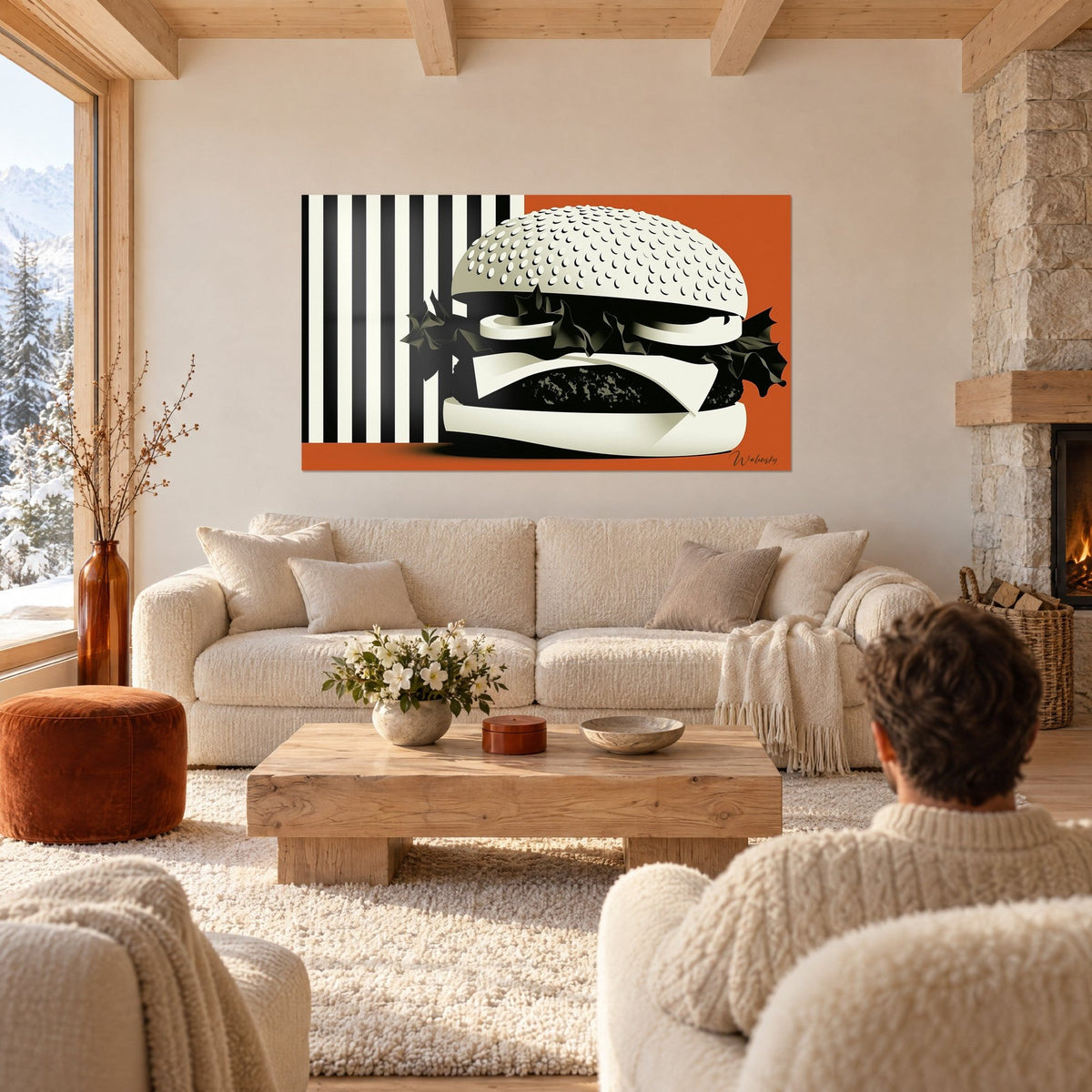 Tableau burger graphique aux sésames crème sur fond orange vif et rayures noires, au-dessus d'un canapé dans un salon lumineux