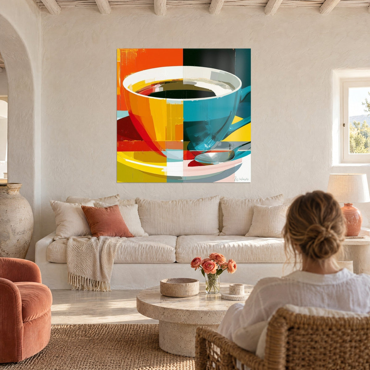 Tableau tasse géante coupée en deux, orange et bleu sarcelle, café noir et cuillère, au-dessus d'un canapé dans un salon lumineux