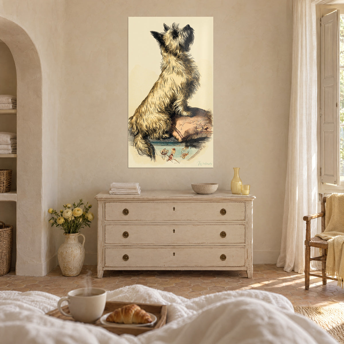 Cuadro terrier sentado erguido sobre las patas traseras, pelaje beige y negro rayado, cojín rosado; cómoda blanca, encima de una cama en un dormitorio claro