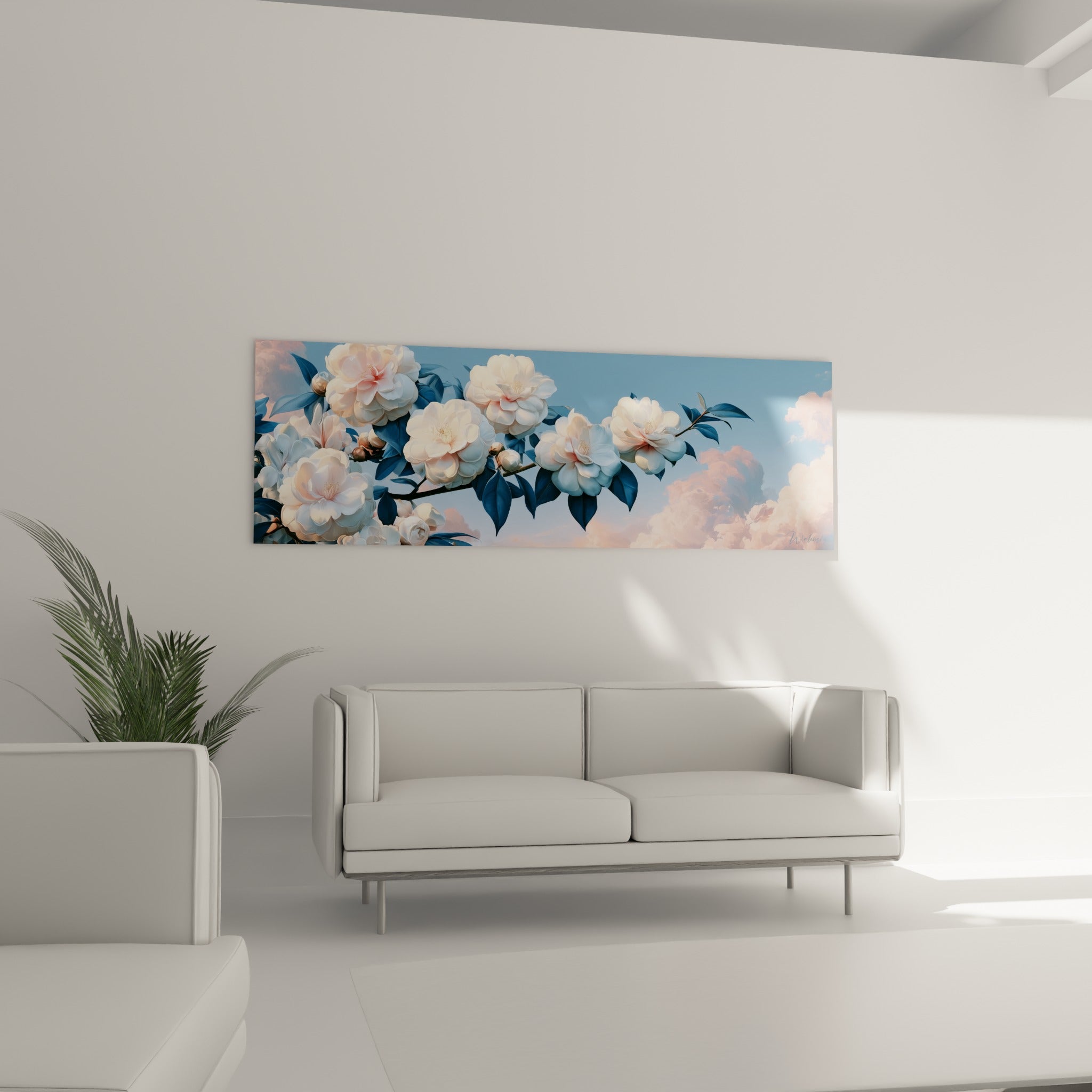 Fleurs de camélia blanc aux teintes rosées au-dessus d'un canapé dans un salon lumineux