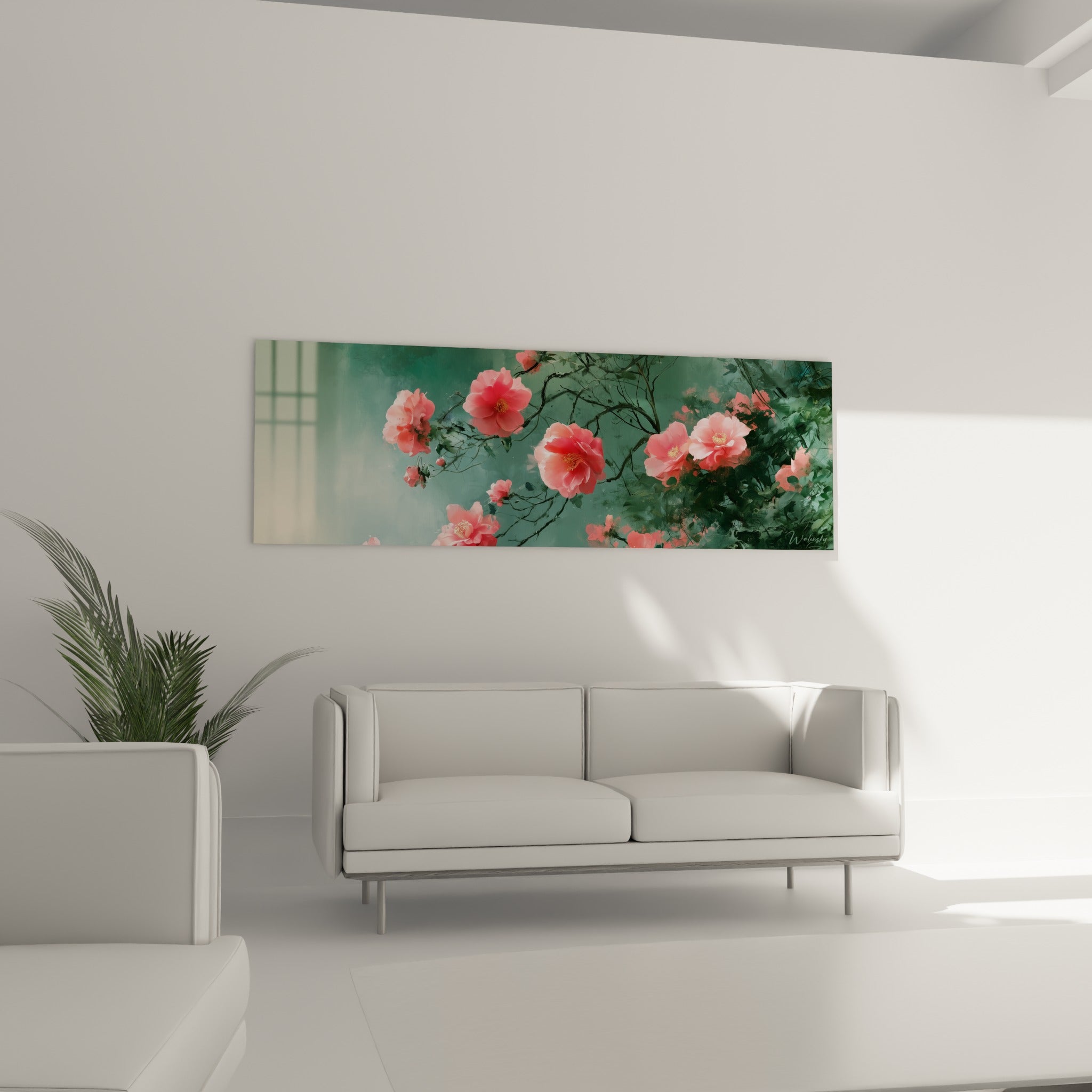 Branches fleuries de camélia rose et vert émeraude dominent un canapé dans un salon lumineux et épuré
