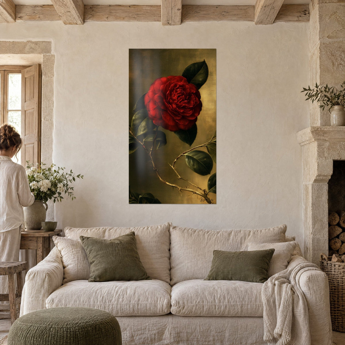 Wall art deep purple camellia with dark green leaves on a patinated gold background, a woman seen from behind, above a sofa in a bright living room