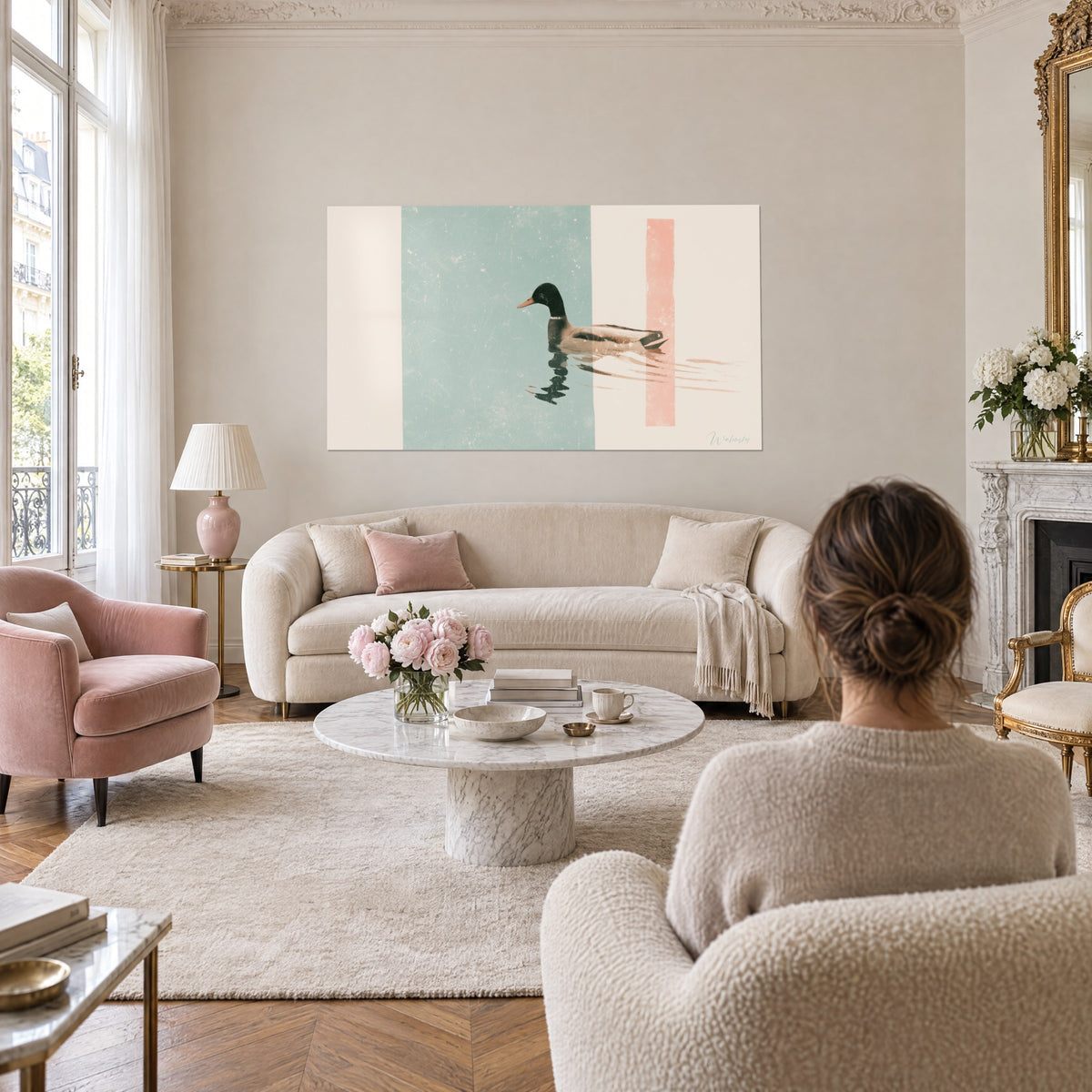 Wall art of a mallard gliding over sea-green water, vertical coral stripe, above a sofa in a bright living room