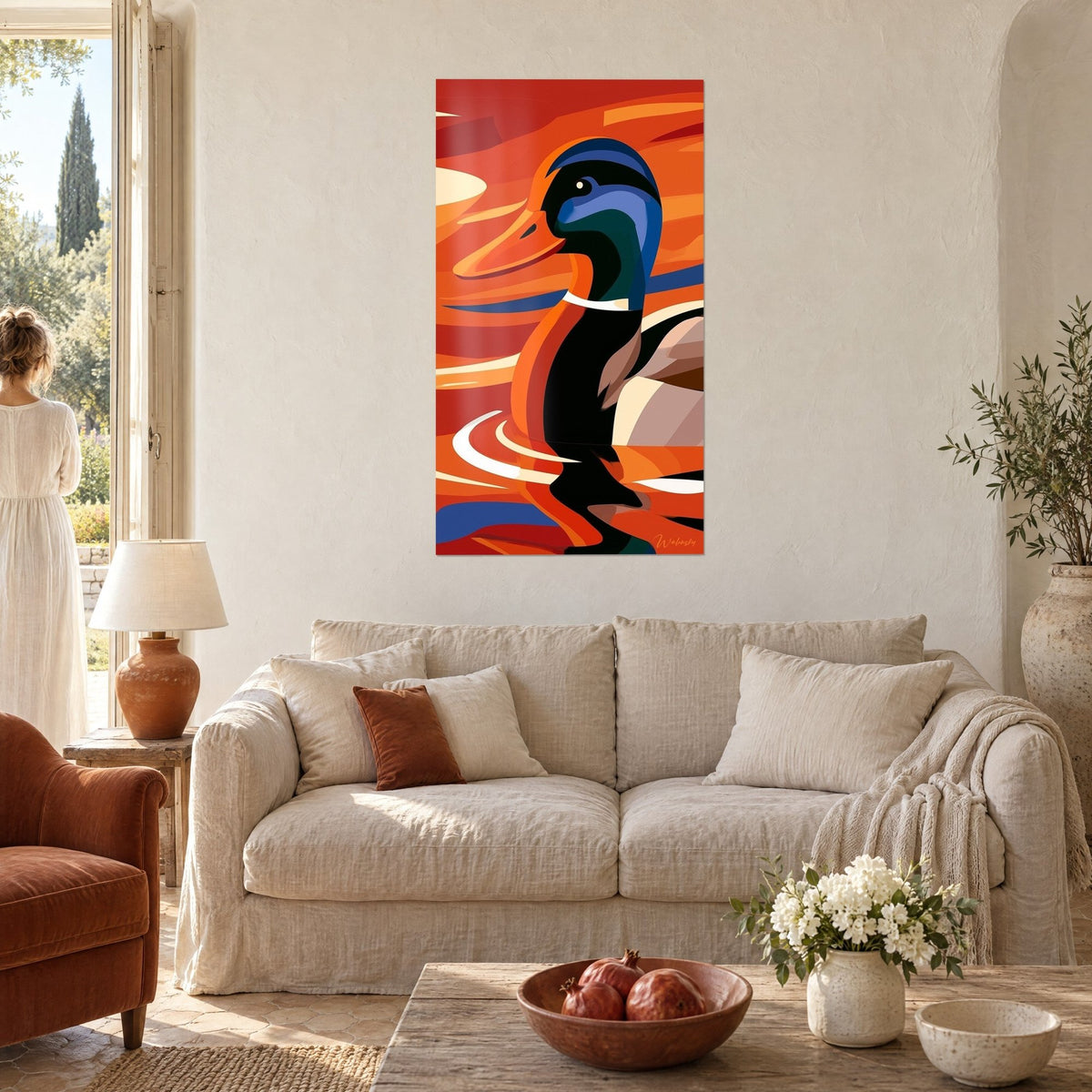 Tableau colvert à tête bleue et bec orange sur fond rouge ardent, une femme de dos au-dessus d'un canapé dans un salon lumineux