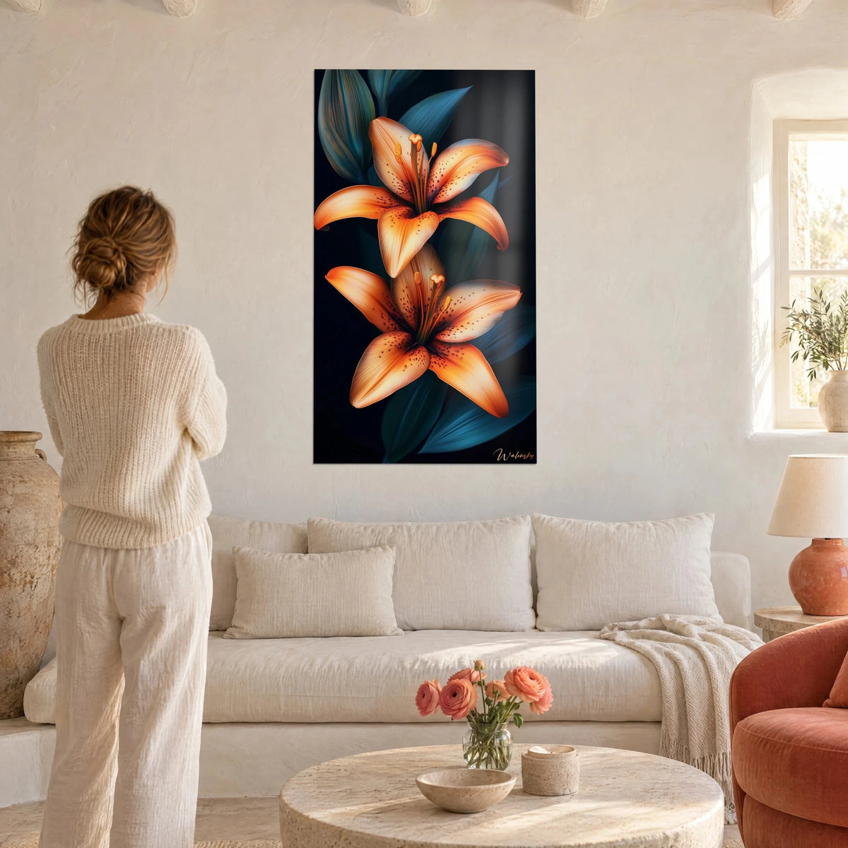 Tableau lys tigré orange aux pétales mouchetés sur fond noir, femme de dos, au-dessus d'un canapé dans un salon lumineux