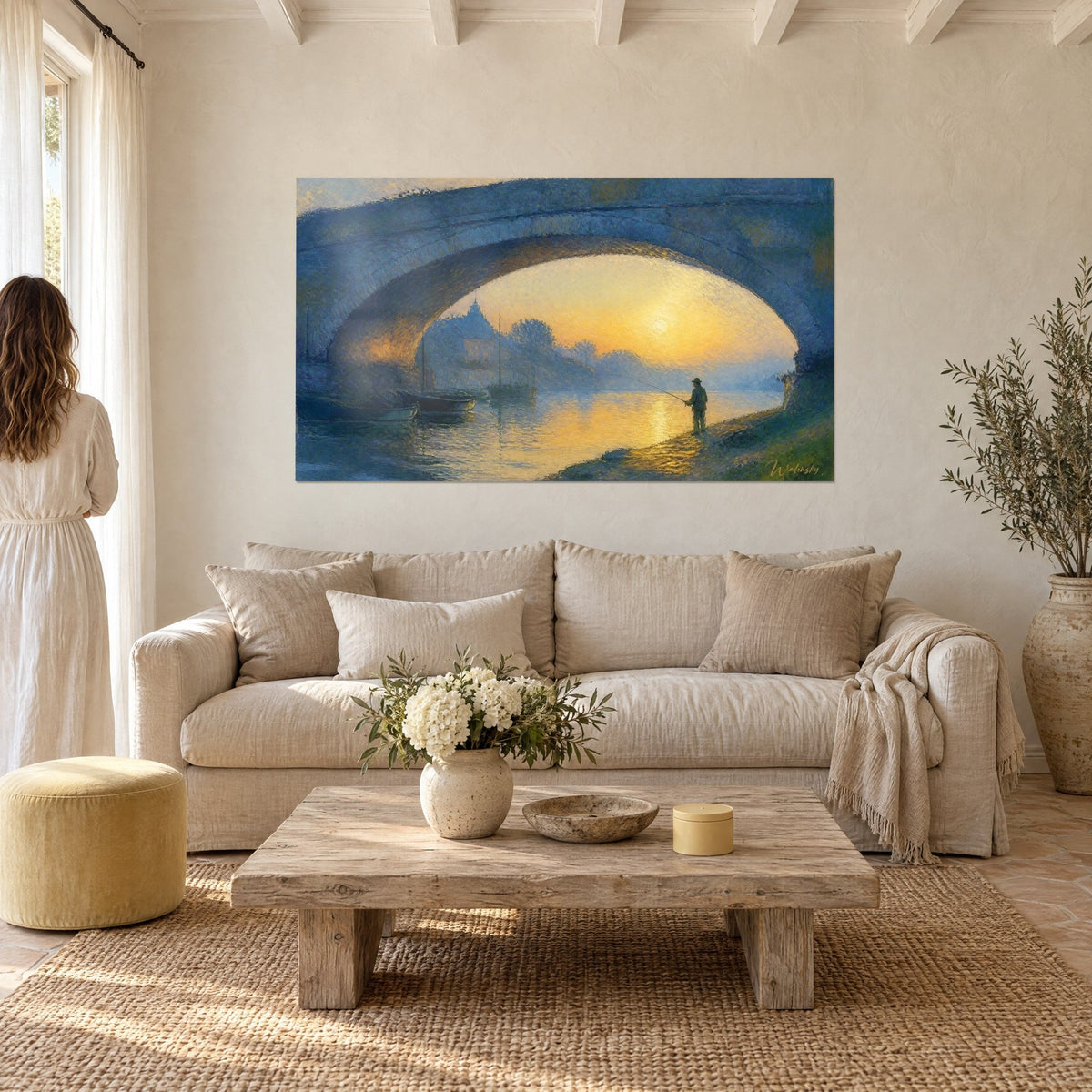 Wall art fisherman under a blue stone arch, golden sun in the opening, above a sofa in a bright living room