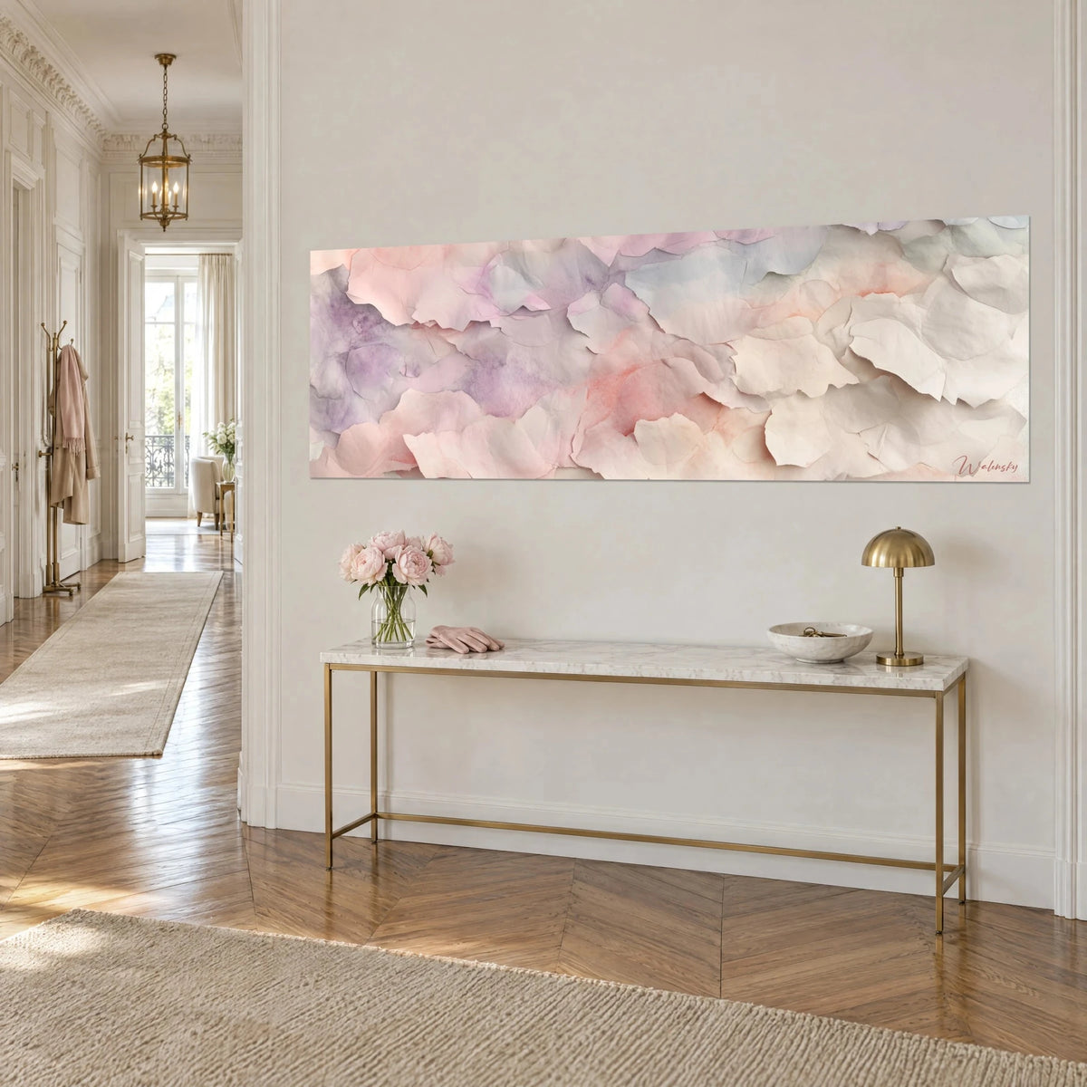 Wall art with layers of torn paper in cream beige and soft pink, hung on a white wall above a gilded console, Haussmann-style entrance