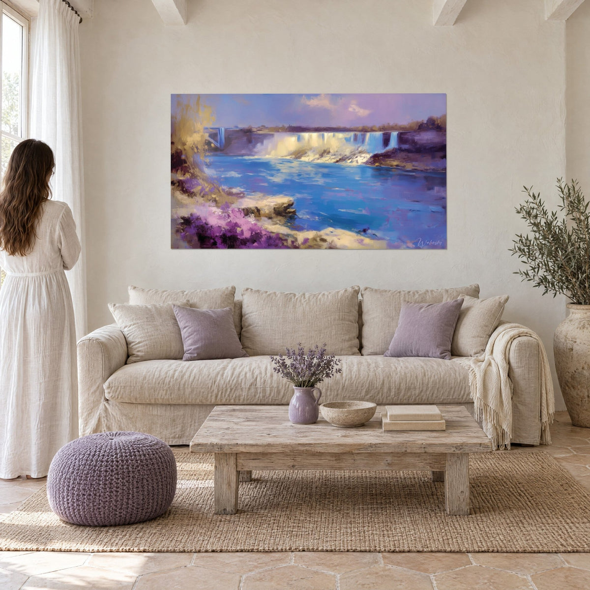 Wall art impressionist waterfall with cobalt blue waters and golden foam, purple heather in the foreground, above a sofa in a bright living room