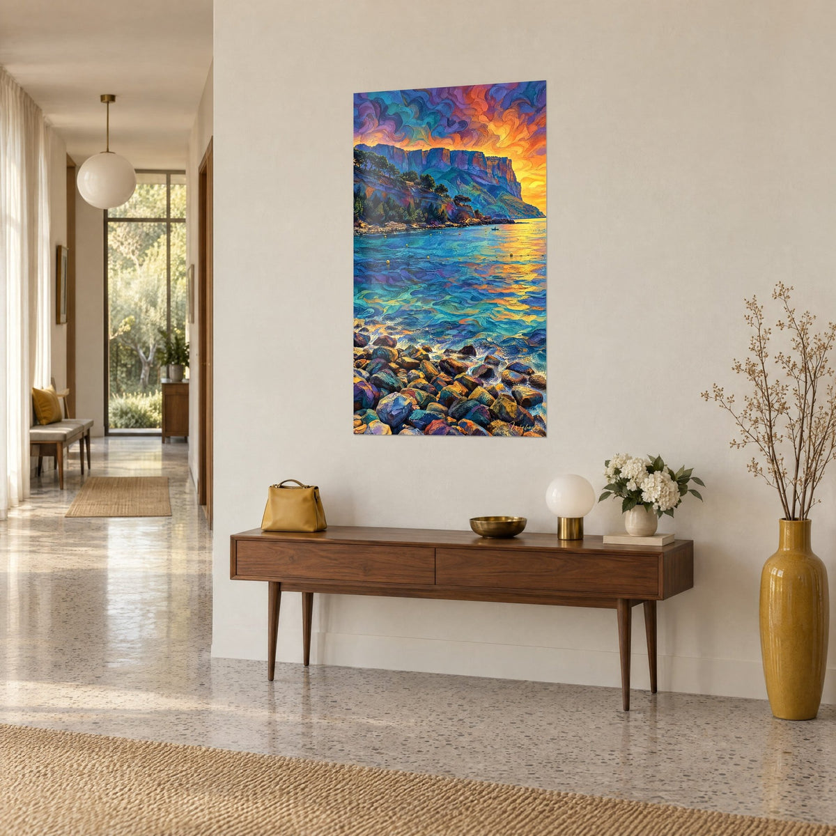 Wall art of the Calanque de Cassis with a blazing orange and purple sky, blue-green sea and colourful pebbles, on a hallway wall