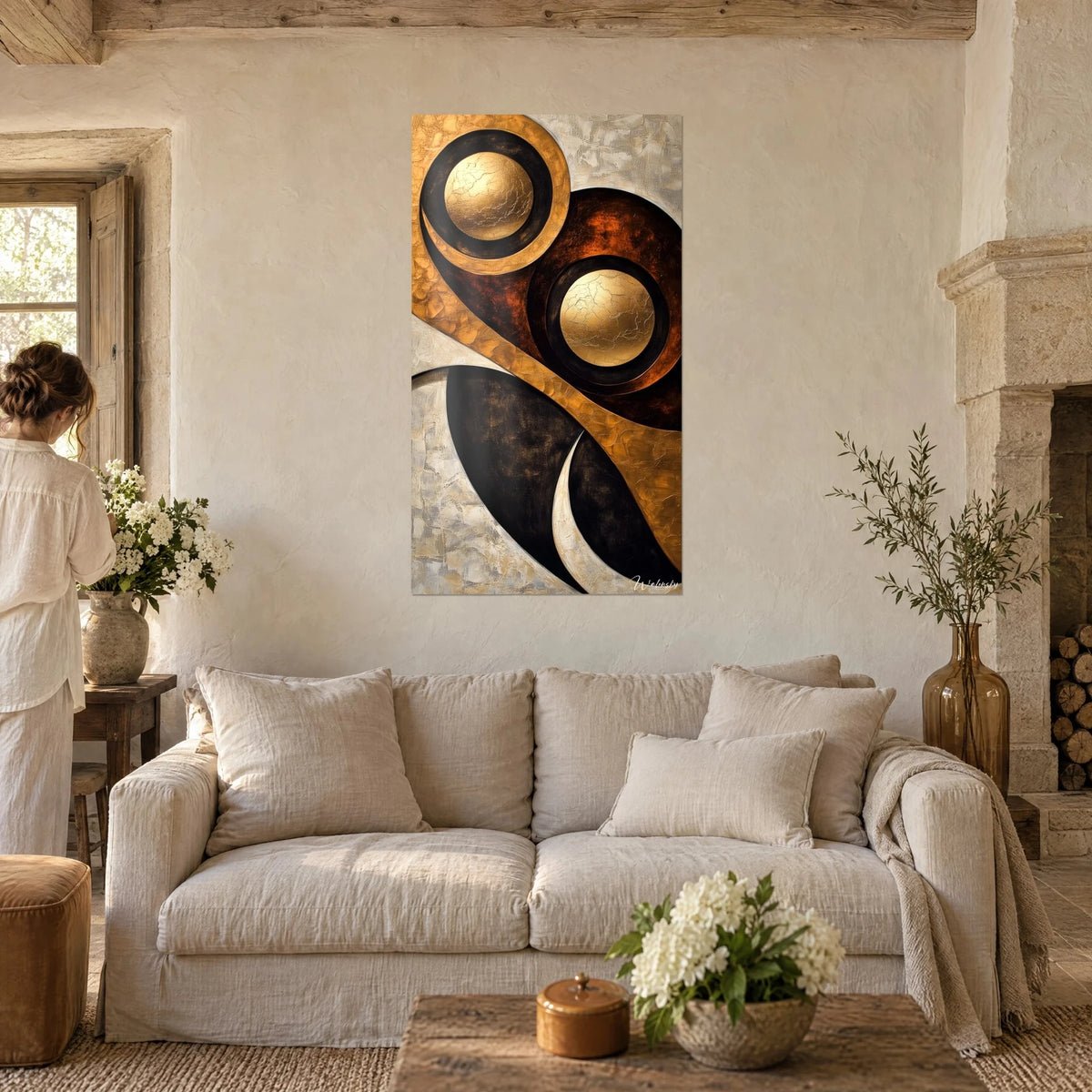 Wall art with cracked gold circles on black and copper background, ochre swirl, above a sofa in a bright living room