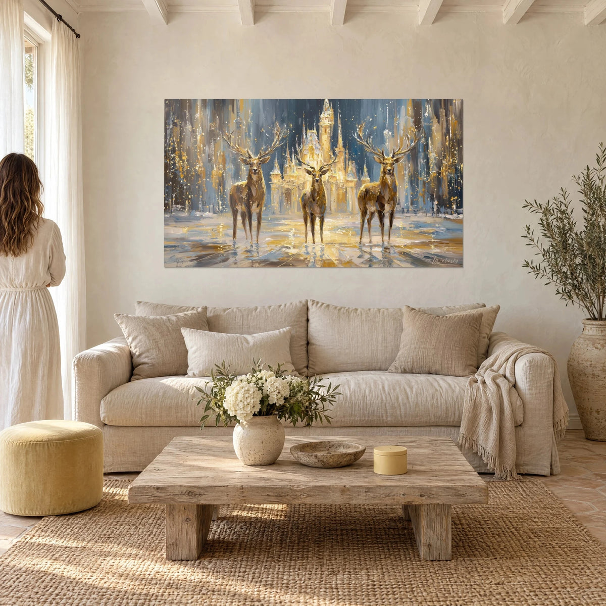Wall art three stags with spreading antlers before a fairytale castle, golden ochre and midnight blue, above a sofa in a bright living room