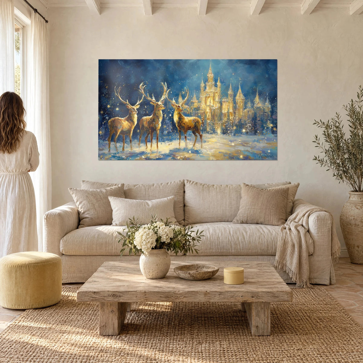 Wall art three golden deer in the snow in front of an illuminated castle, midnight blue and gold, above a sofa in a bright living room