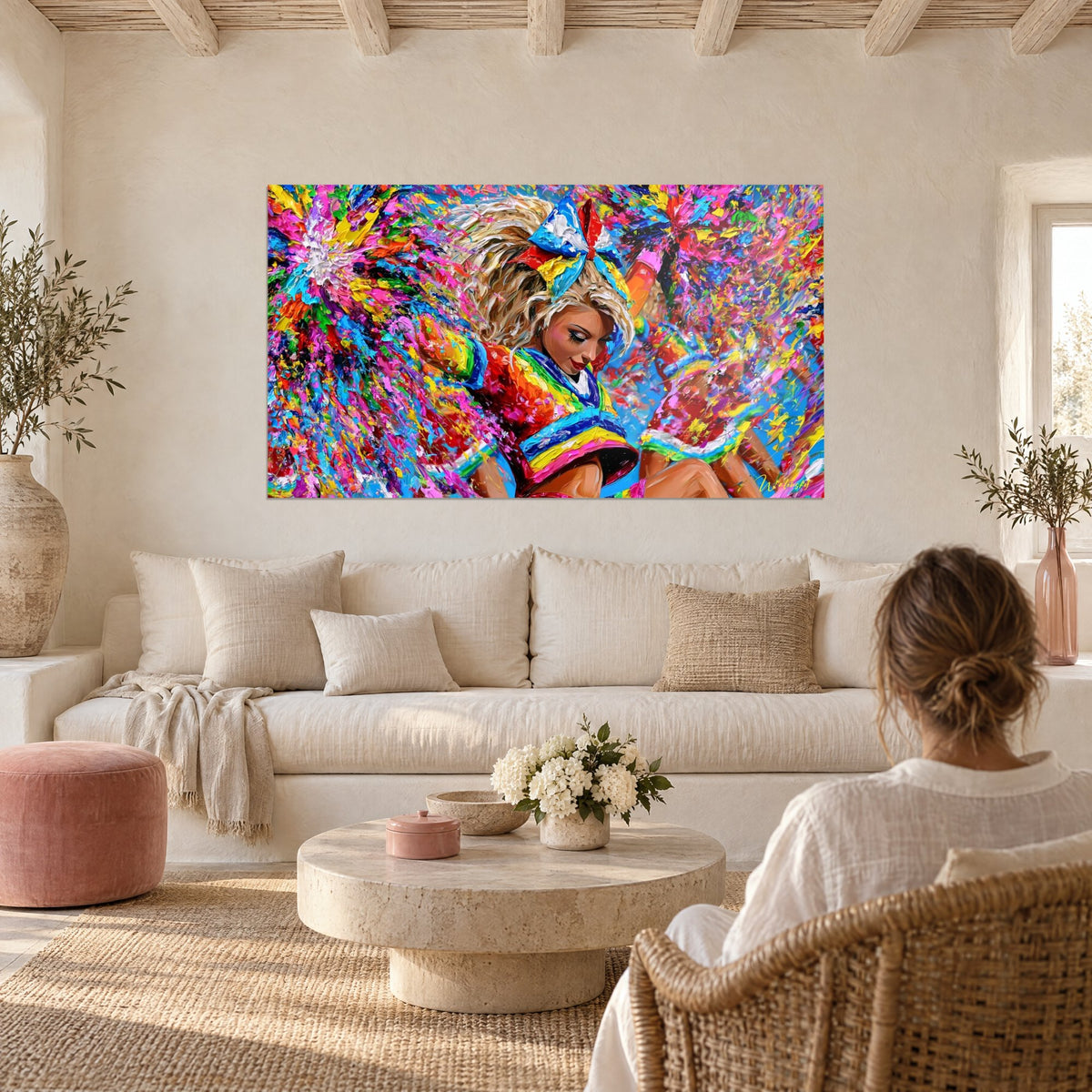 Wall art blonde pom-pom girl with blue and red bow, bright confetti, above a sofa in a sunlit living room