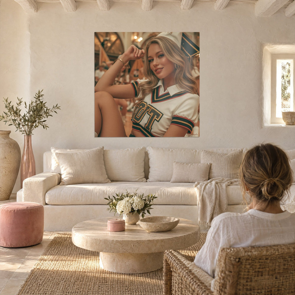 Wall art blonde cheerleader in white polo with gold and green piping, hand in her hair, above a sofa in a bright living room
