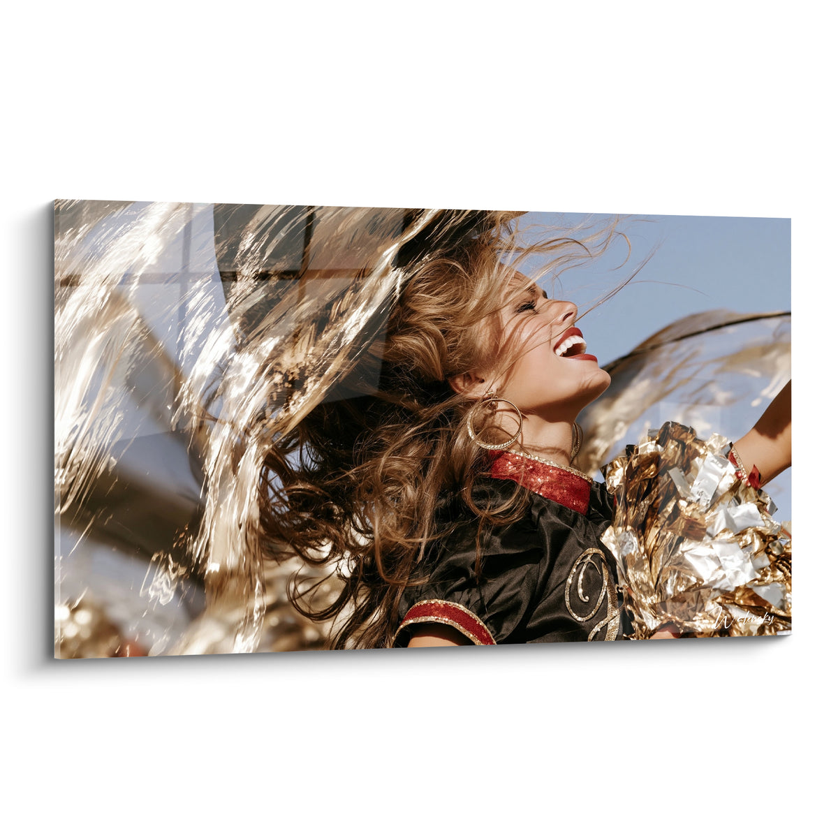Wall art of a smiling cheerleader with golden brown hair, sparkling pom-poms under a clear blue sky