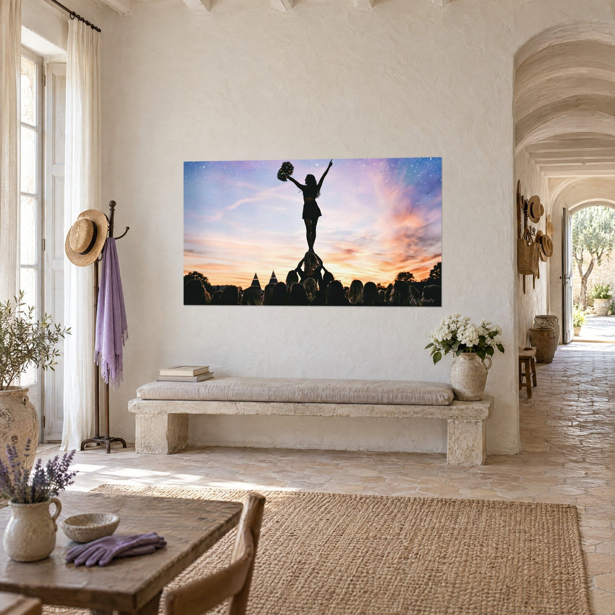 Wall art cheerleader pyramid against a pink and blue starry sky, hung on a beige wall of a Provençal farmhouse