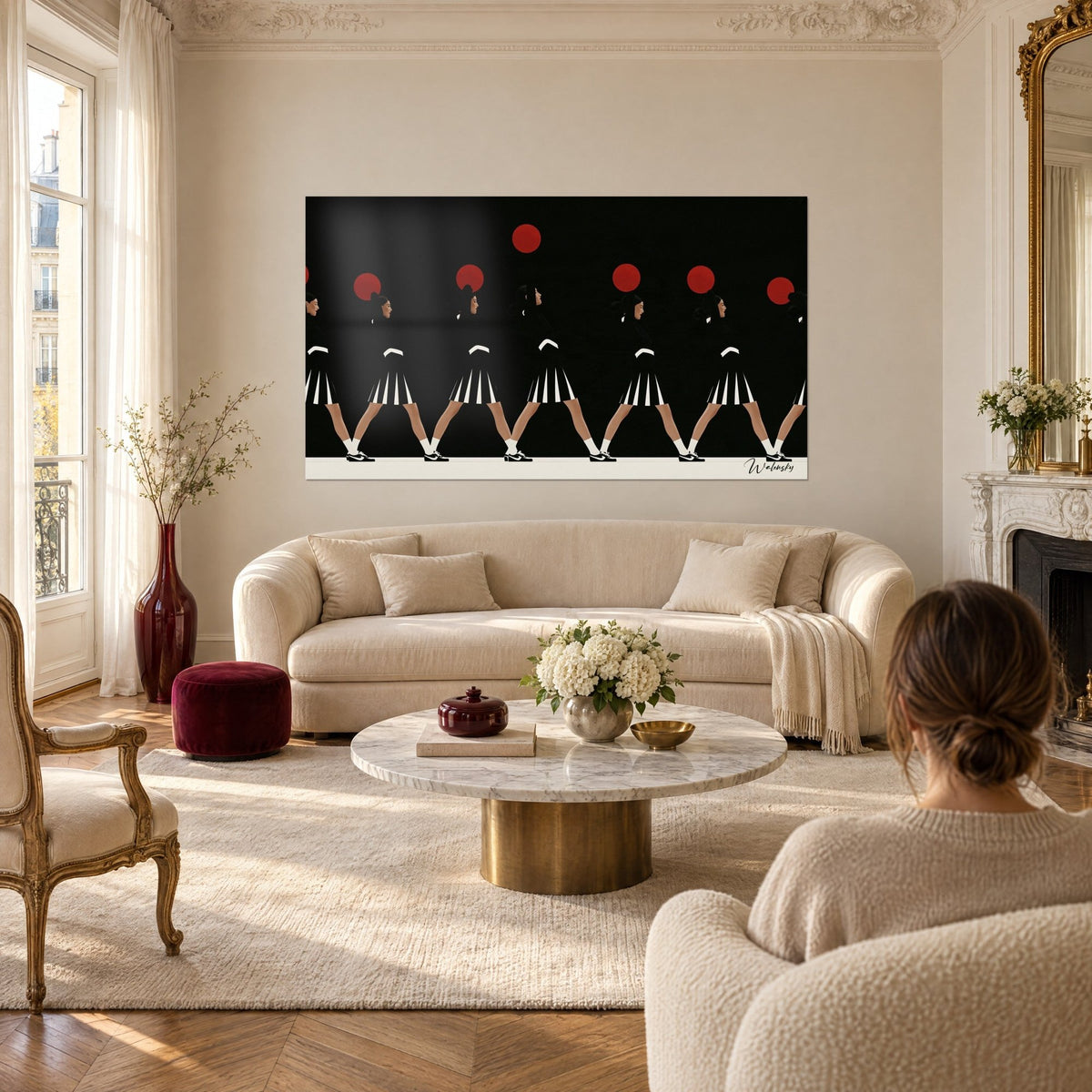 Wall art revue dancers in black and white pleated skirts, red pom-poms on a black background, above a sofa in a bright living room