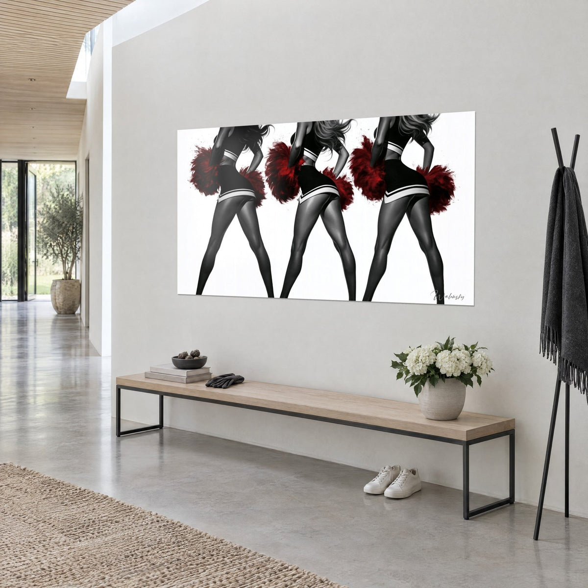 Tableau trio de meneuses en noir et blanc agitant des pompons rouge carmin, cheveux au vent, vu de trois-quarts sur un mur gris clair