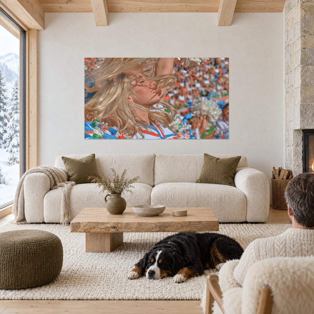 Tableau pom-pom girl aux boucles blondes soufflées par le vent, tribune bleue et orange, au-dessus d'un canapé dans un salon lumineux