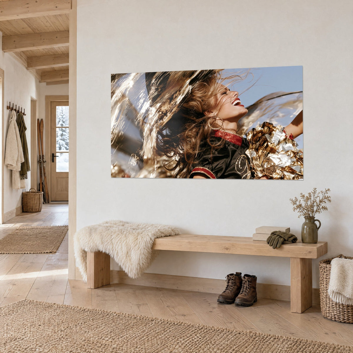 Wall art of a cheerleader with scarlet lipstick, whipping hair and gold glitter pom-poms, on a chalet wall