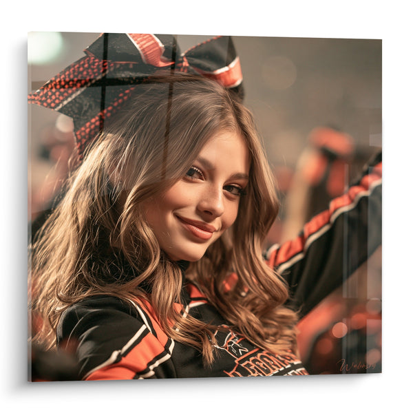 Tableau Cheerleader châtain aux rubans noir et orange - Sourire complice au stade - Edition Cheerleader