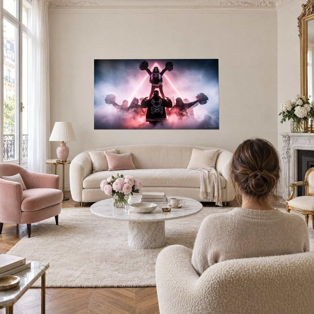 Wall art cheerleader pyramid under a pink neon triangle, midnight blue mist, rear view above a sofa in a bright living room