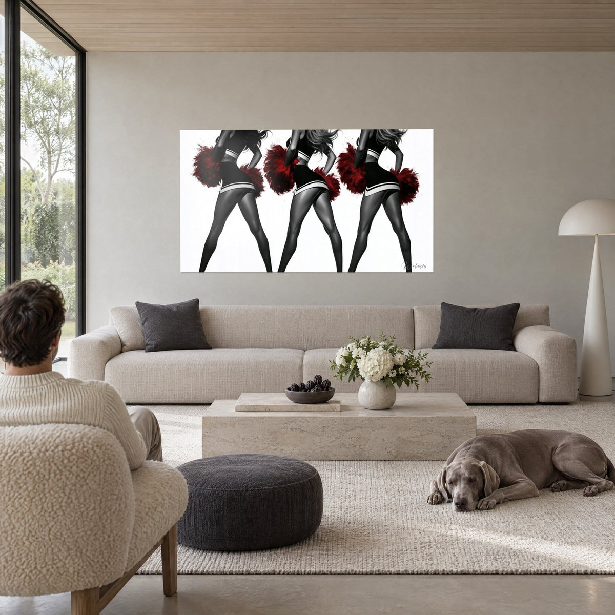 Tableau pom-pom girls en jupe noire, pompons rouge sang, jambes en collants gris, fond blanc, au-dessus d'un canapé dans un salon lumineux
