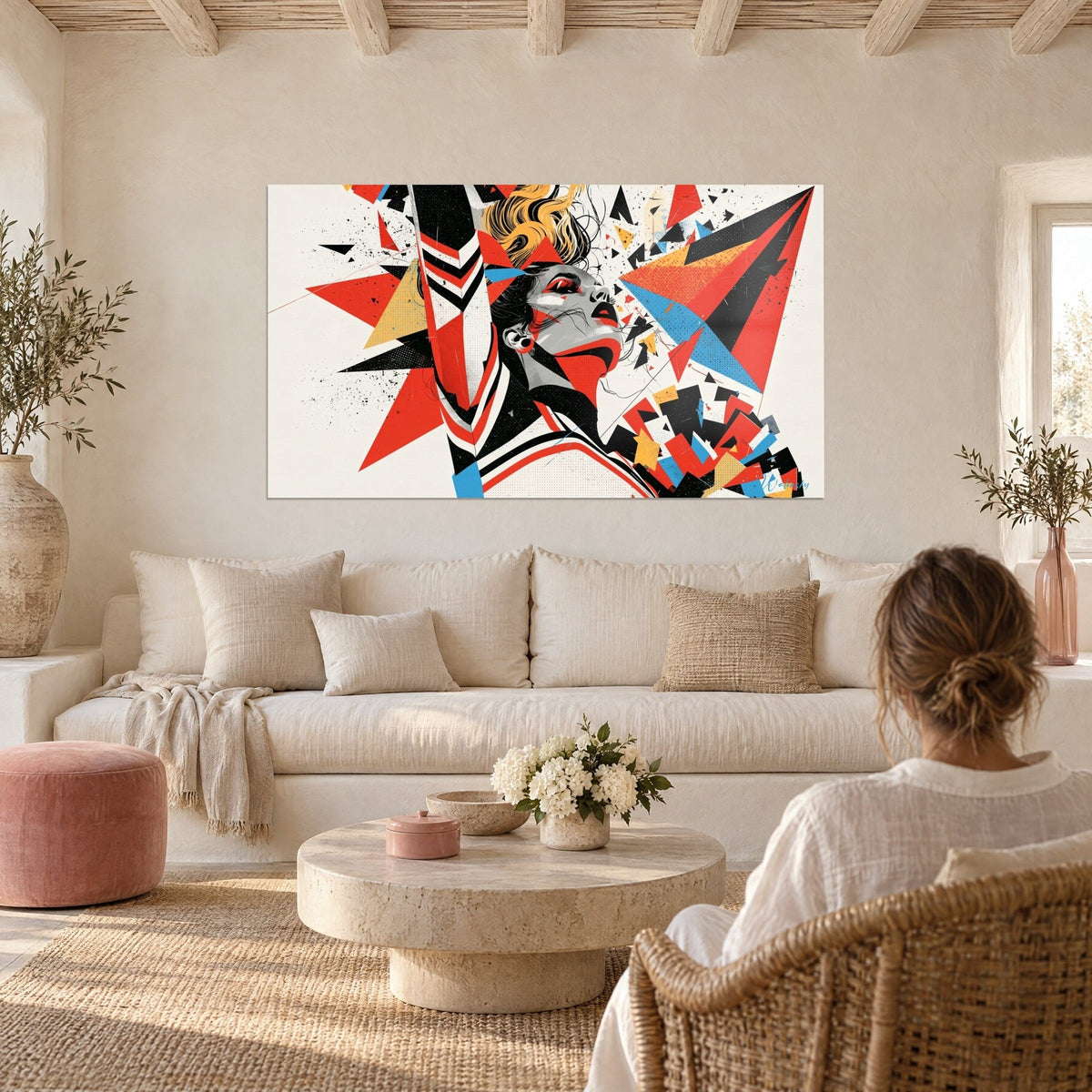 Wall art cheerleader with raised arm, red and blue shards on an ivory background, above a sofa in a bright living room