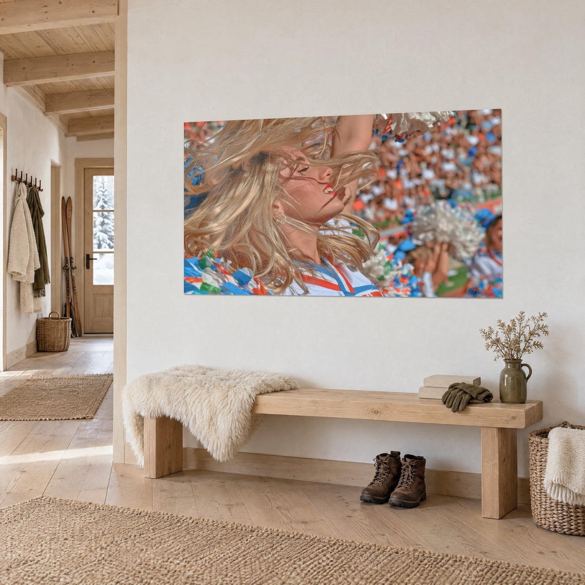 Tableau meneuse de claque blonde, rouge à lèvres corail, pompons argentés flous, posé sur un mur blanc de chalet en bois clair