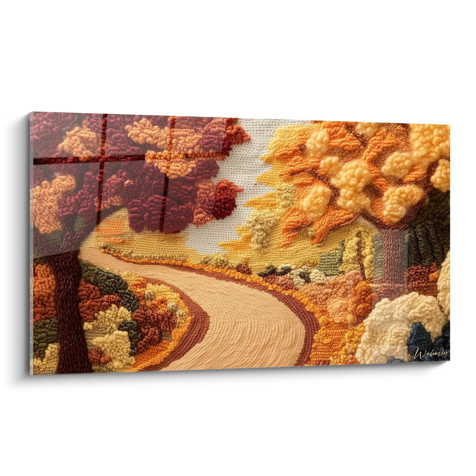 Un tableau textile représentant un chemin sinueux beige traversant un paysage automnal, avec des arbres en relief rouge bordeaux et orange, créé par technique de crochet tridimensionnel aux textures variées sur fond écru.
