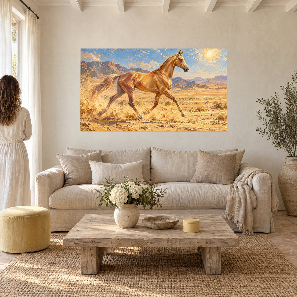 Gemälde goldener Hengst im Trab auf ockerfarbenem Sand, blauer Himmel und blasse Sonne, über einem Sofa in einem lichtdurchfluteten Wohnzimmer