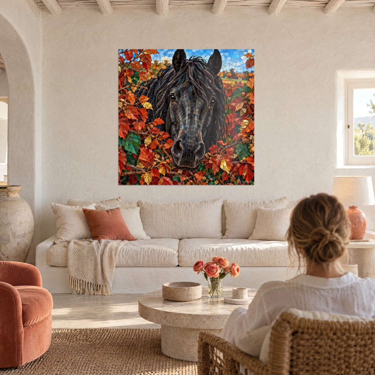 Tableau cheval frison à la crinière charbon, fourré de feuilles rousses et vertes, au-dessus d'un canapé dans un salon lumineux