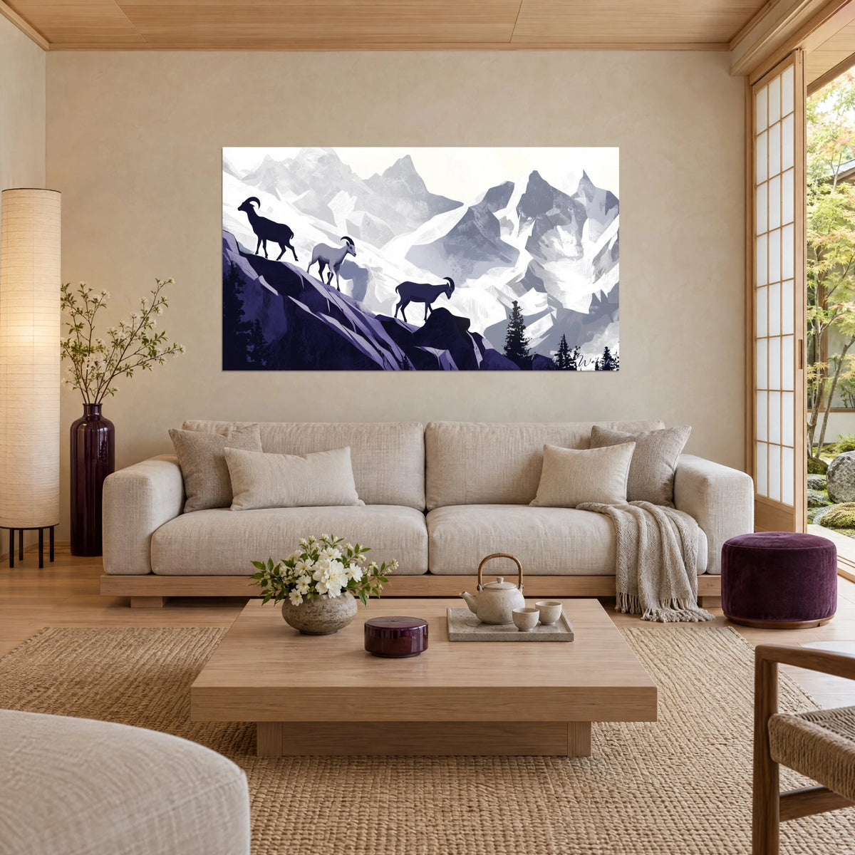 Wall art three ibex in indigo silhouette on a rocky ridge, glacier-white and pearl-grey peaks, above a sofa in a bright living room