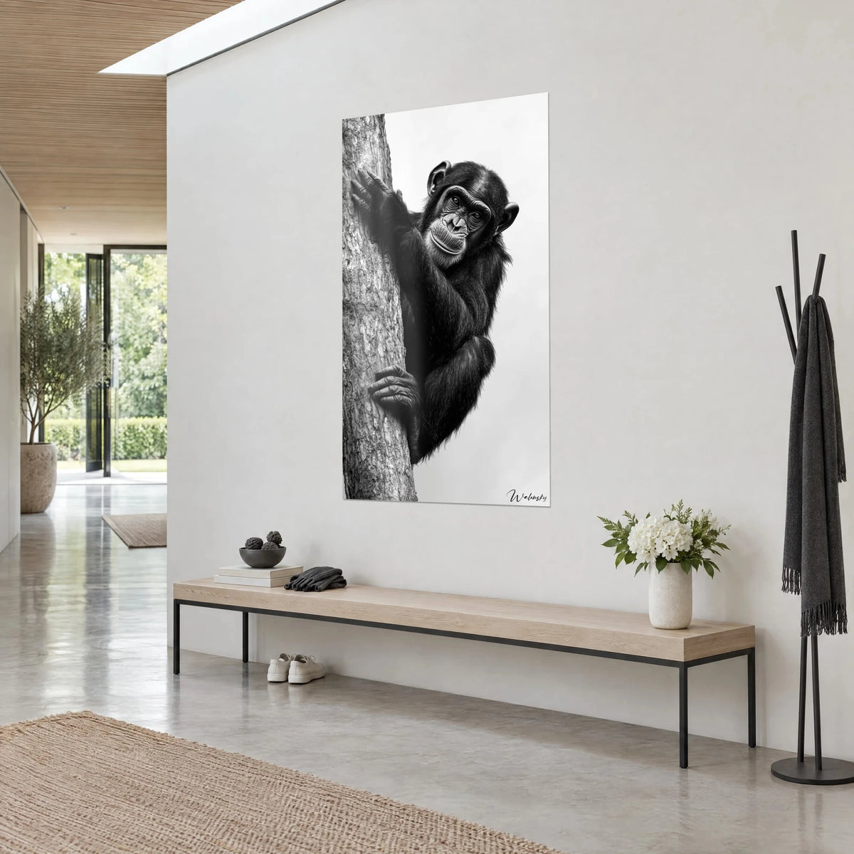 Wall art primate with ebony fur embracing silvery bark, milky white background, three-quarter view, light wooden bench