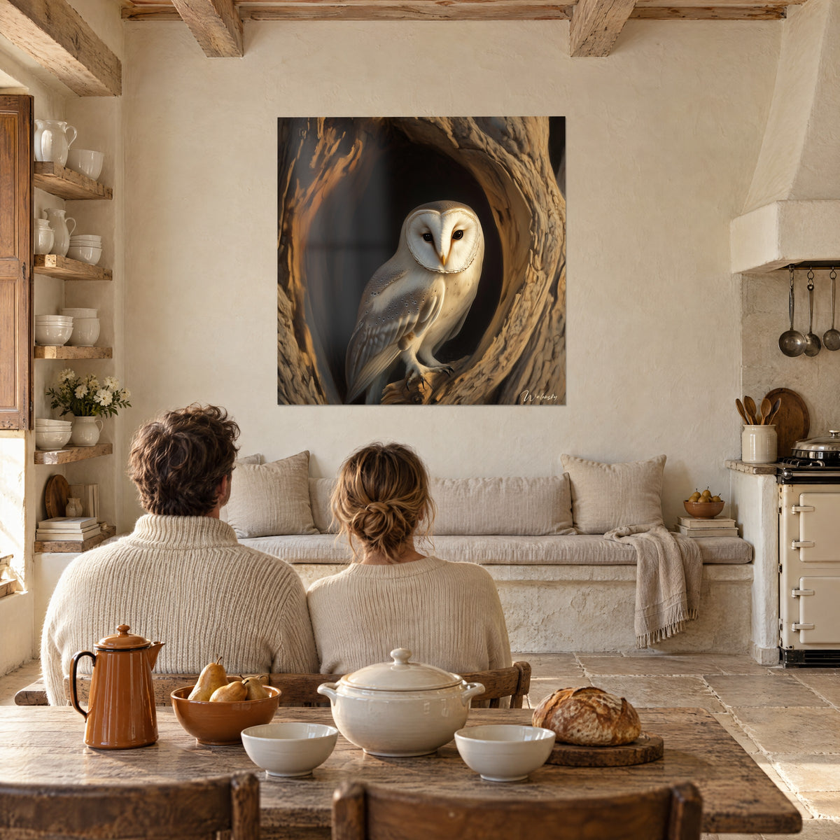 Wall art owl with a white heart-shaped face, dark talons resting on ochre wood, in a stone kitchen with exposed beams
