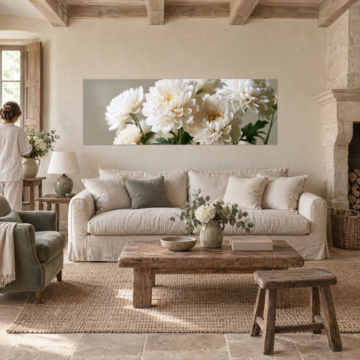 Wall art ivory chrysanthemum bouquet on a taupe background, frizzy petals, a person seen from behind, above a sofa in a bright living room