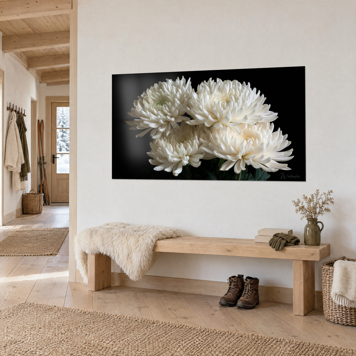 Wall art bouquet of vibrant ivory flowers on deep black background, light wood bench and sheepskin rug, chalet entrance
