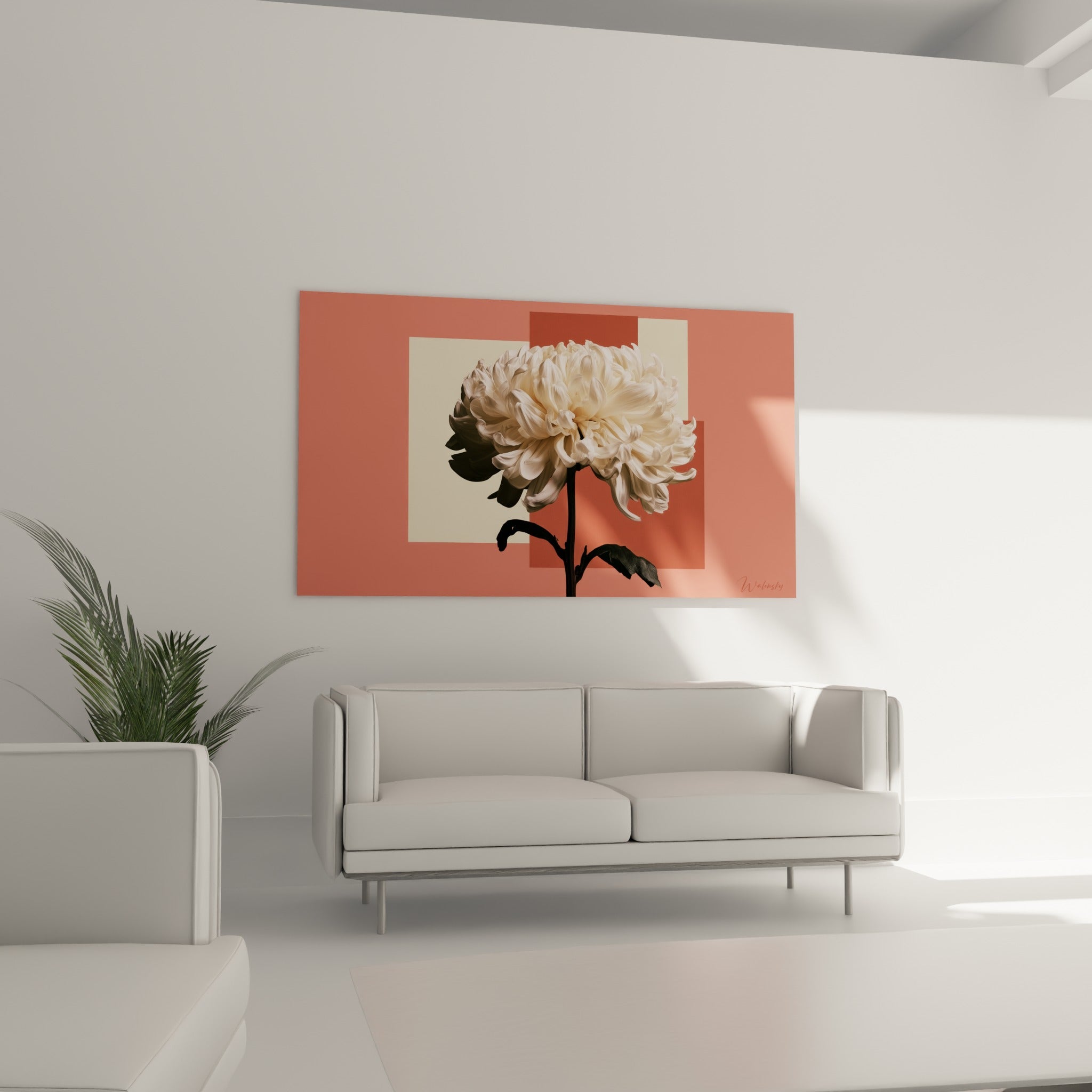 Pétales ivoire et blancs du chrysanthème contrastant avec les blocs corail, au-dessus d'un canapé dans un salon lumineux