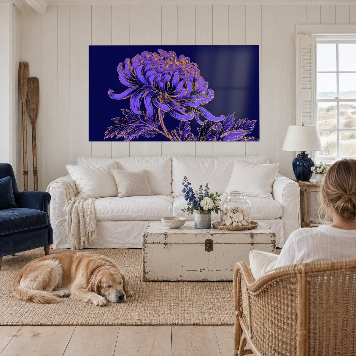 Wall art purple chrysanthemum with wavy petals outlined in gold on a midnight blue background, lying retriever, above a sofa in a bright living room