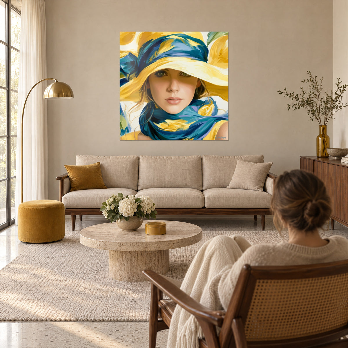 Wall art female portrait under a wide yellow hat, duck-egg blue scarf, two people seen from behind above a sofa in a bright living room