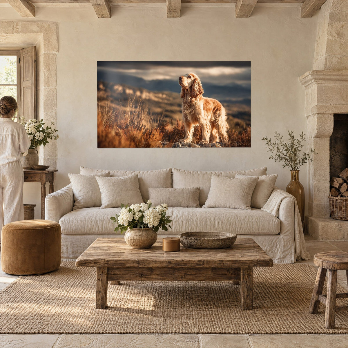 Wall art golden cocker spaniel with long curly ears on a rock, russet heather and grey sky, above a sofa in a bright living room