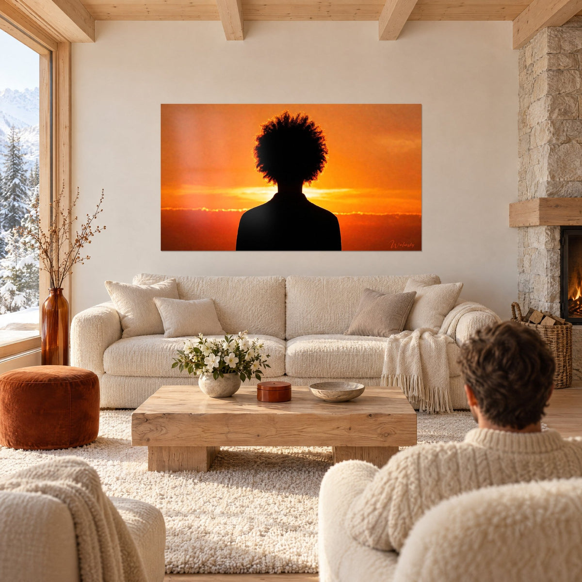 Wall art black silhouette with afro mane cut out against a blazing orange sky, above a sofa in a bright living room