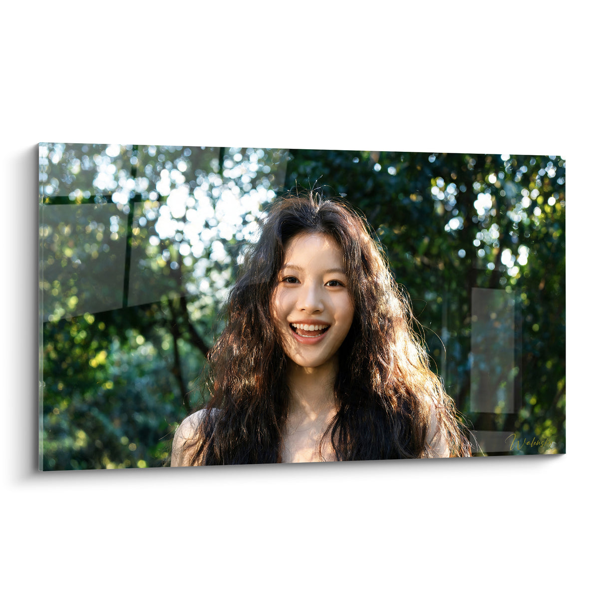 Wall art with wavy brown hair and a radiant smile, emerald green background and golden light in natural bokeh